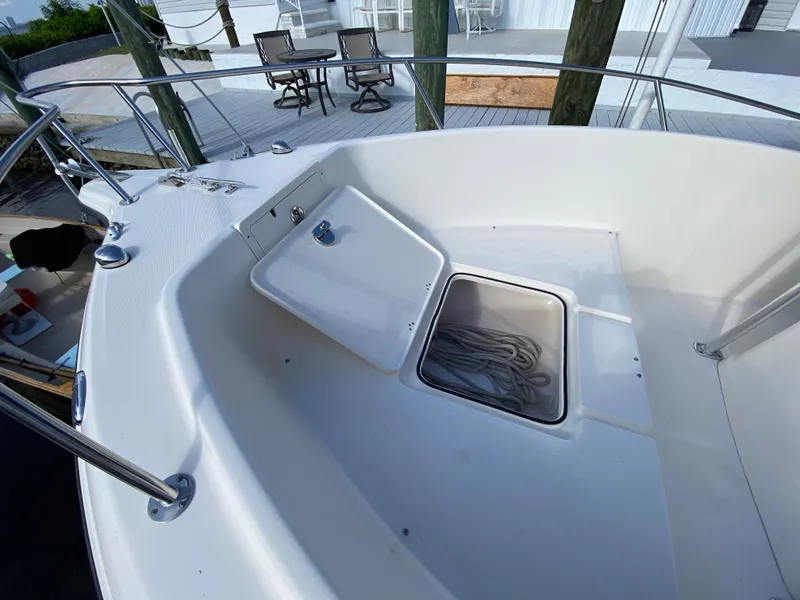 Slide: The Image of 2011 Pursuit C 200 Center Console boat with open storage compartment on deck. - 7