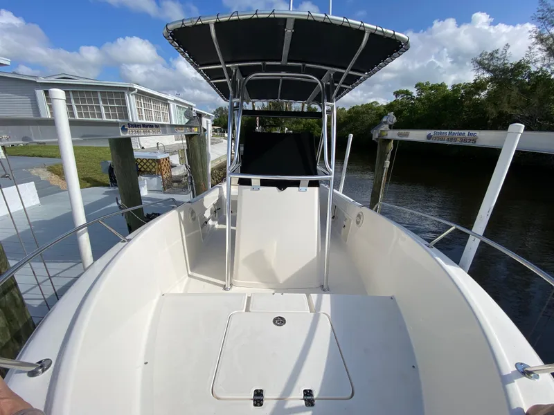 Slide: The Image of 2011 Pursuit C 200 Center Console boat docked by a riverside. - 8