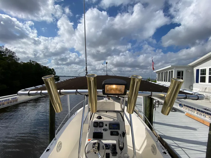 Slide: The Image of 2011 Pursuit C 200 Center Console boat docked under a cloudy sky. - 9