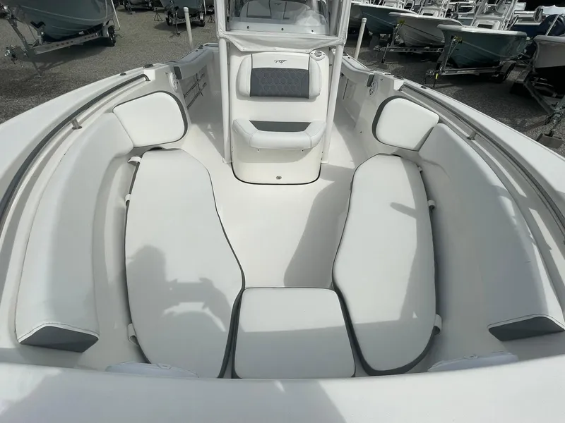 Slide: The Image of 2019 Tidewater 220 CC Adventure boat interior with cushioned seating and sleek design. - 10