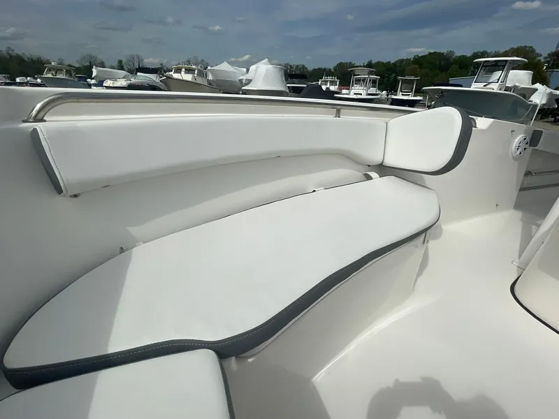 Slide: The Image of 2019 Tidewater 220 CC Adventure boat with white cushioned seating area. - 11