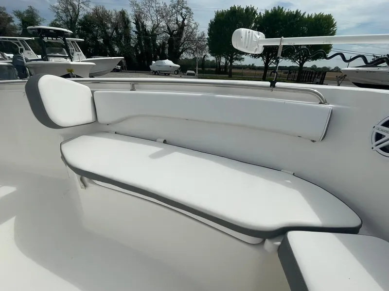 Slide: The Image of 2019 Tidewater 220 CC Adventure boat interior with white cushioned seating. - 12