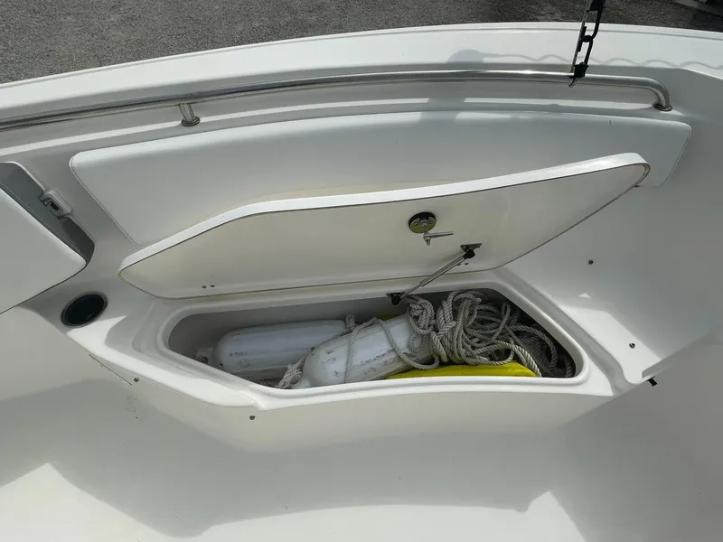 Slide: The Image of 2019 Tidewater 220 CC Adventure boat storage compartment with ropes and equipment. - 14