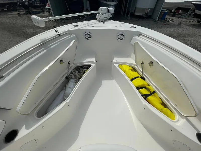 Slide: The Image of 2019 Tidewater 220 CC Adventure boat with open storage compartments and visible equipment. - 16