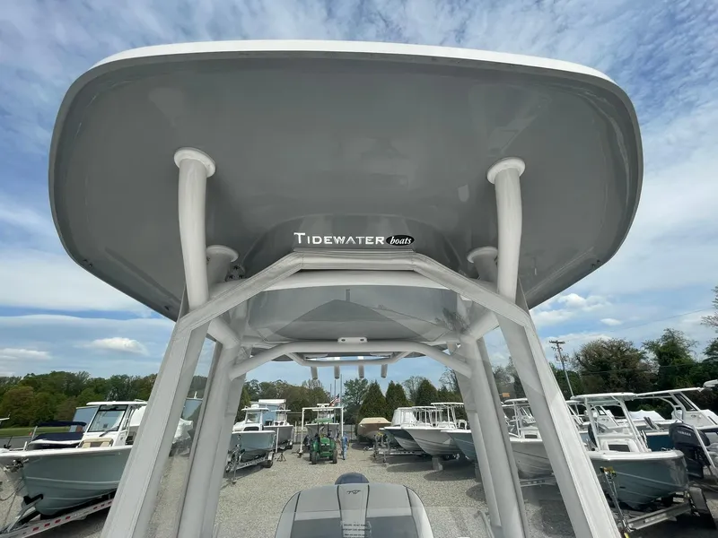 Slide: The Image of 2019 Tidewater 220 CC Adventure boat with T-top, displayed in a marina setting. - 18