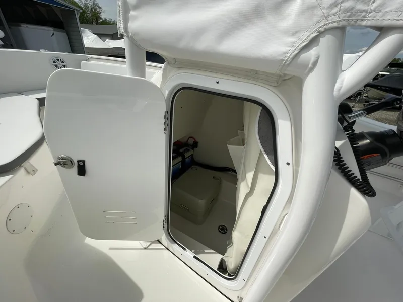 Slide: The Image of 2019 Tidewater 220 CC Adventure boat storage compartment with open door. - 21