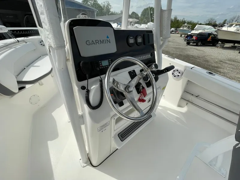 Slide: The Image of 2019 Tidewater 220 CC Adventure boat console with Garmin navigation system and steering wheel. - 22