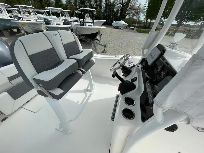 Slide: The Image of 2019 Tidewater 220 CC Adventure boat interior with dual seats and control panel. - 26