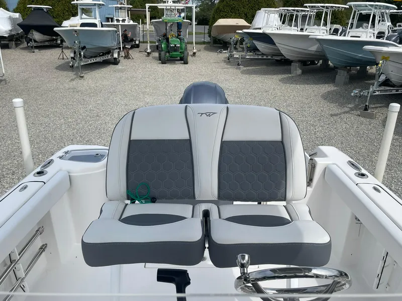 Slide: The Image of 2019 Tidewater 220 CC Adventure boat with dual seating, displayed in a marina. - 27