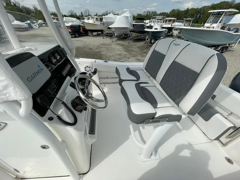 Slide: The Image of 2019 Tidewater 220 CC Adventure boat interior with Garmin system and cushioned seating. - 28