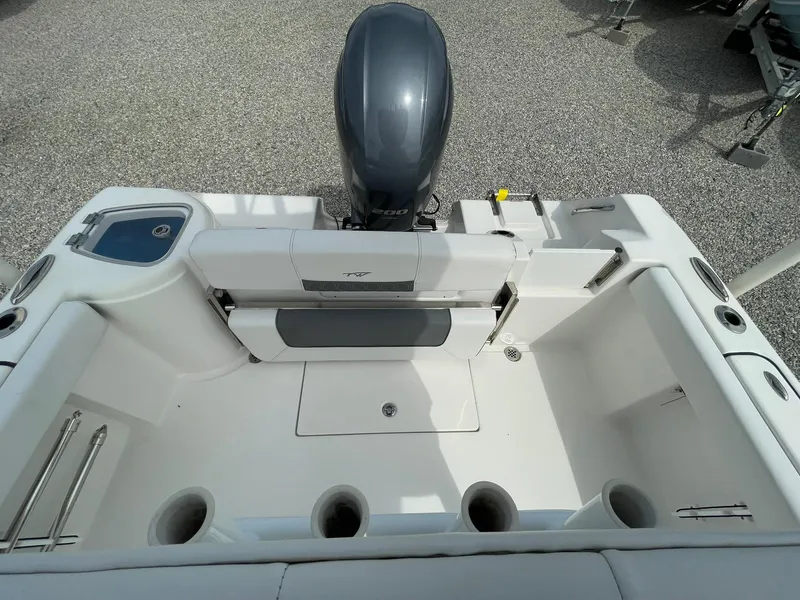 Slide: The Image of 2019 Tidewater 220 CC Adventure boat interior with motor, rod holders, and seating. - 31