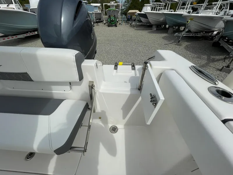 Slide: The Image of 2019 Tidewater 220 CC Adventure boat interior with seating and open hatch. - 35