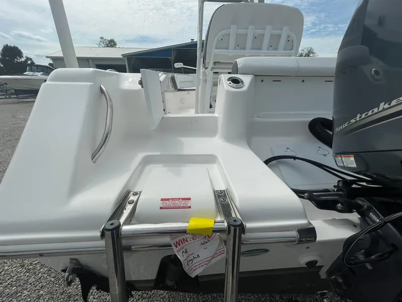 Slide: The Image of 2019 Tidewater 220 CC Adventure boat stern with ladder and outboard motor. - 36