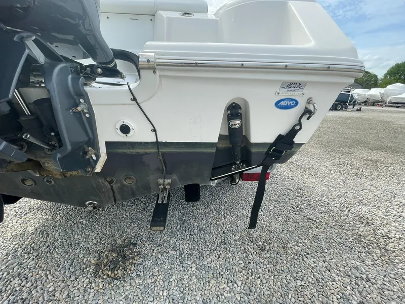 Slide: The Image of 2019 Tidewater 220 CC Adventure boat stern with motor and trim tabs on gravel. - 39