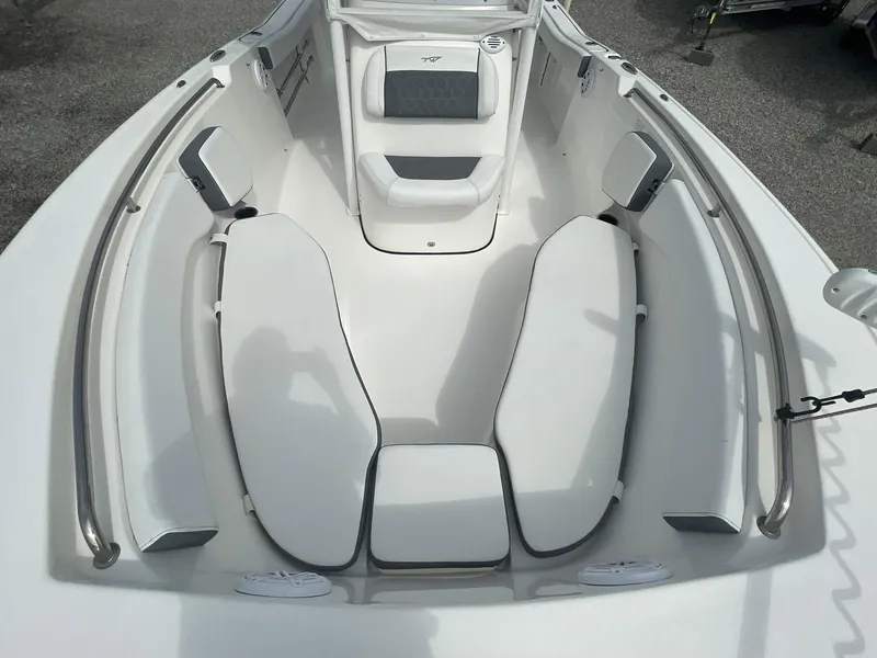 Slide: The Image of 2019 Tidewater 220 CC Adventure boat interior with cushioned seating and stainless steel rails. - 9
