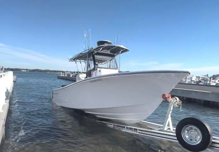 Slide: The Image of 2023 Onslow Bay 27 Offshore boat on trailer at marina dock. - 1