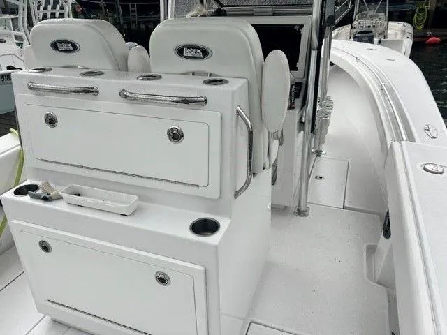 Slide: The Image of 2023 Onslow Bay 27 Offshore boat interior with seating and storage compartments. - 10