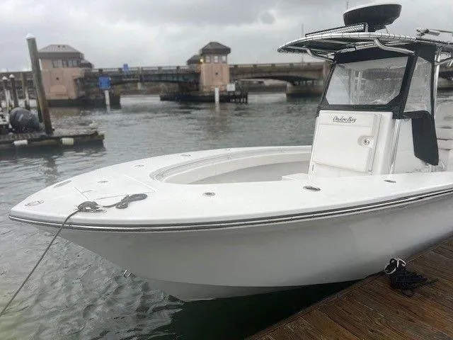 Slide: The Image of 2023 Onslow Bay 27 Offshore boat docked near a bridge on a cloudy day. - 5