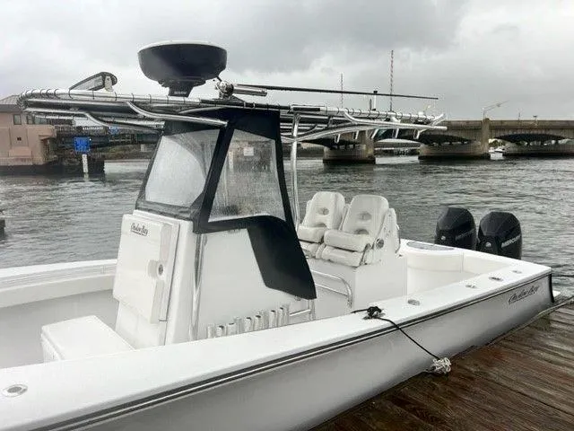 Slide: The Image of 2023 Onslow Bay 27 Offshore boat docked by a bridge on a cloudy day. - 6