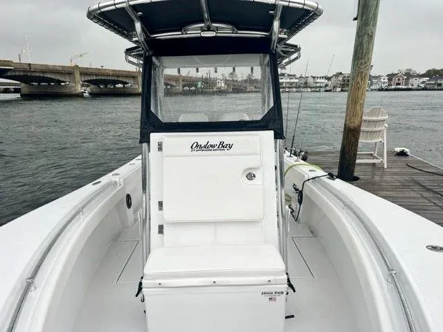 Slide: The Image of 2023 Onslow Bay 27 Offshore boat docked by a waterfront, showcasing sleek design. - 8