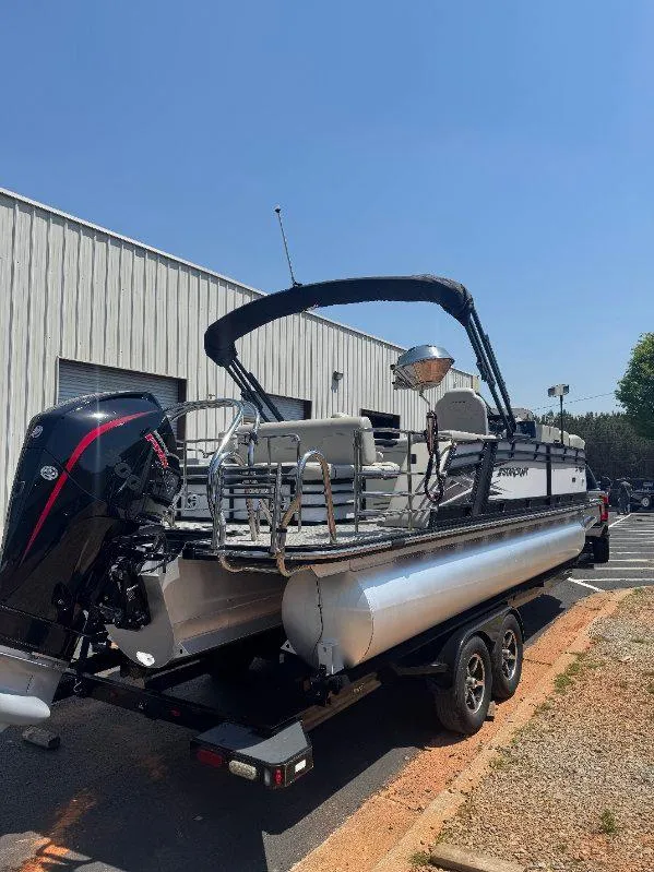 Slide: The Image of 2022 Starcraft SLS 3 Q DH pontoon boat on trailer, parked outside a building. - 5