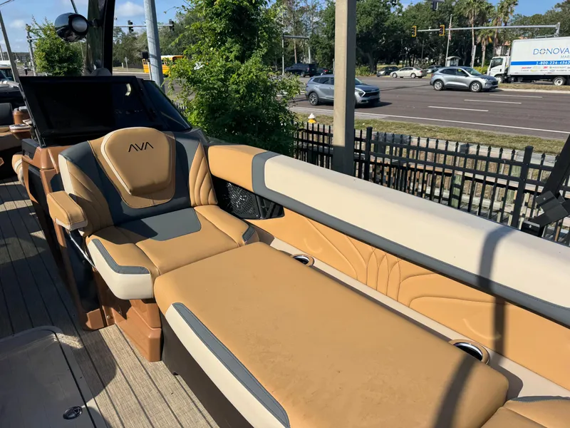 Slide: The Image of Luxurious seating on 2025 Avalon Excalibur 27' boat, featuring tan and gray upholstery. - 13