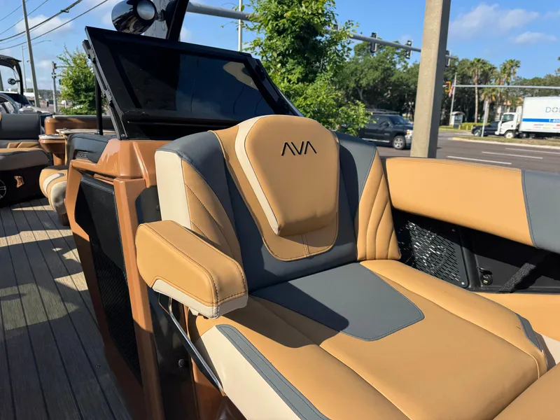 Slide: The Image of 2025 Avalon Excalibur 27' boat interior with tan and gray seating, modern design. - 14