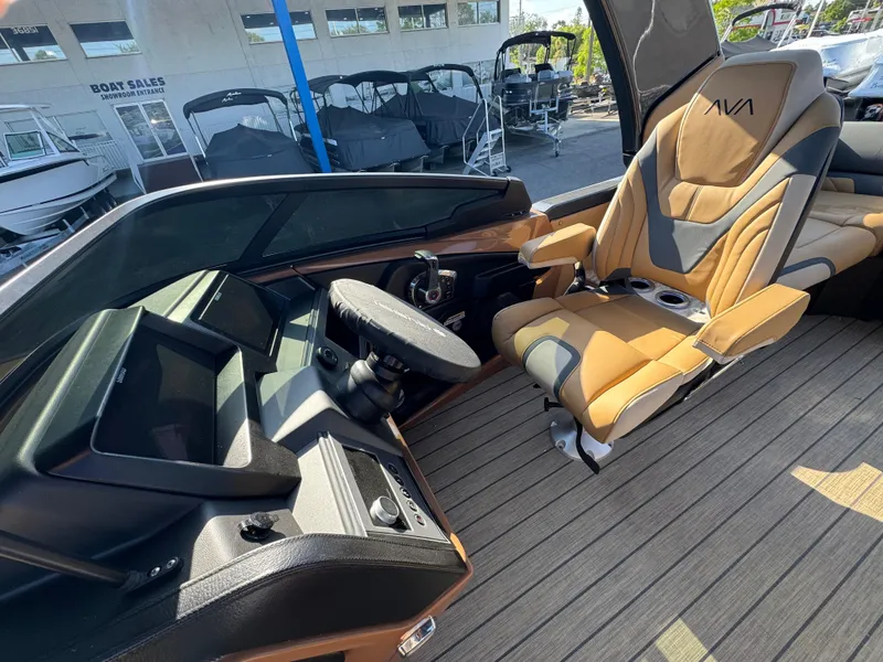 Slide: The Image of 2025 Avalon Excalibur 27' boat interior with modern helm and luxurious captain's chair. - 18