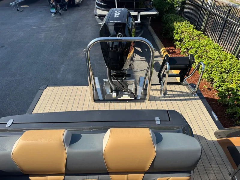 Slide: The Image of 2025 Avalon Excalibur 27' boat with sleek seating and powerful outboard motor. - 21