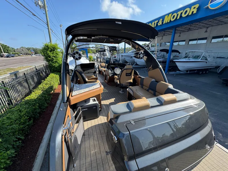 Slide: The Image of 2025 Avalon Excalibur 27' luxury boat at dealership, showcasing sleek design and spacious interior. - 25