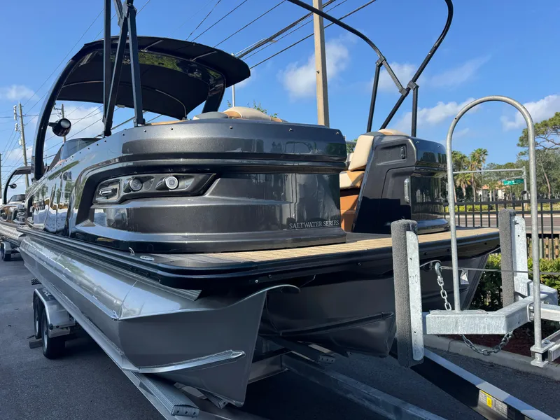 Slide: The Image of 2025 Avalon Excalibur 27' pontoon boat on trailer, sleek design, outdoor setting. - 3