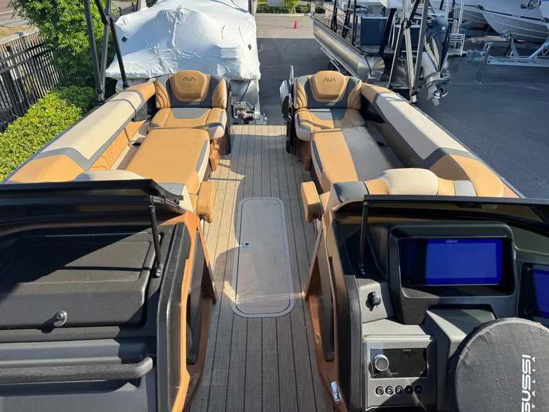 Slide: The Image of 2025 Avalon Excalibur 27' boat interior with luxurious seating and modern dashboard. - 34