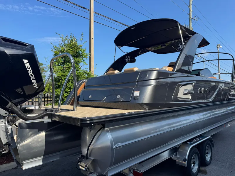 Slide: The Image of 2025 Avalon Excalibur 27' pontoon boat with Mercury engine on trailer. - 6