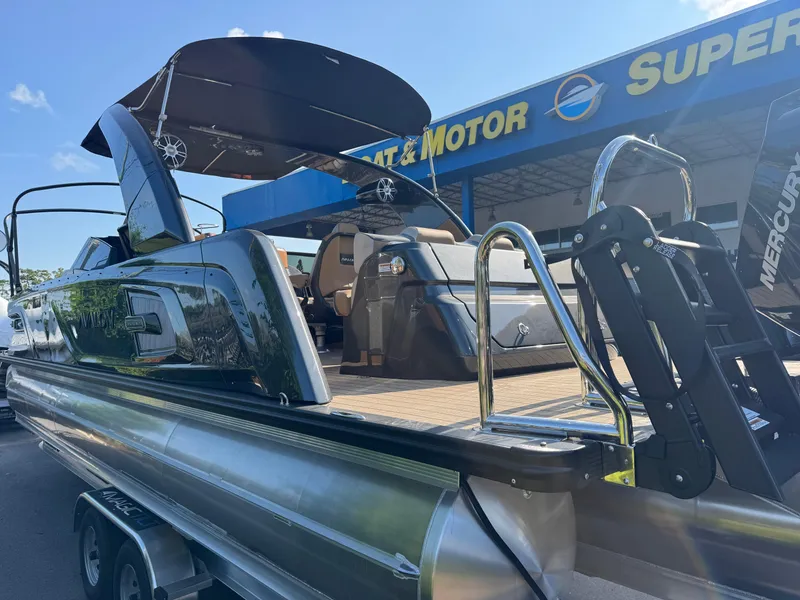 Slide: The Image of 2025 Avalon Excalibur 27' boat at dealership, featuring sleek design and modern amenities. - 9