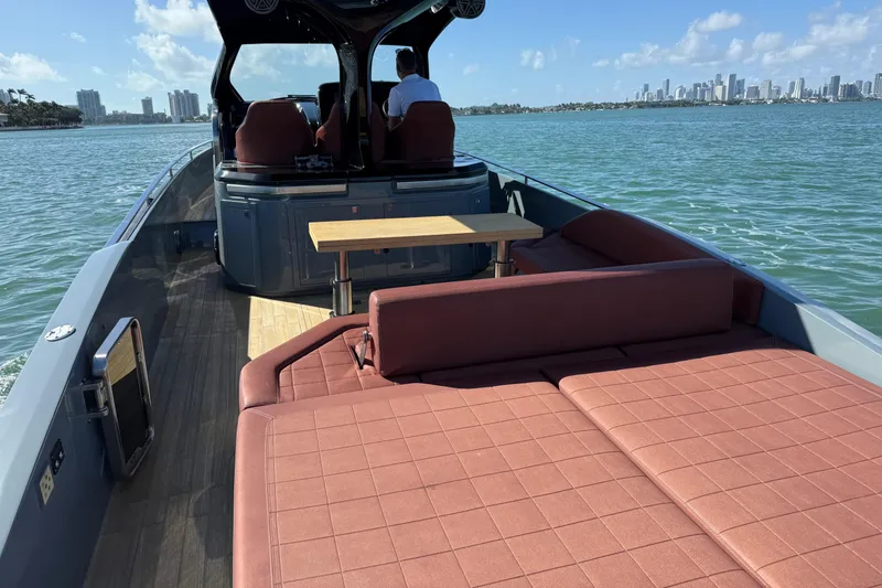 Slide: The Image of 2019 SACS Rebel 40 boat with spacious deck and seating, cruising on a sunny day. - 10