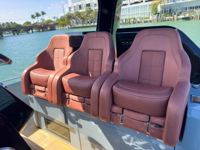 Slide: The Image of Luxurious brown leather seats on a 2019 SACS Rebel 40 boat, with waterfront view. - 13