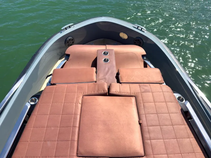 Slide: The Image of Luxurious 2019 SACS Rebel 40 boat with brown cushioned seating on calm water. - 19