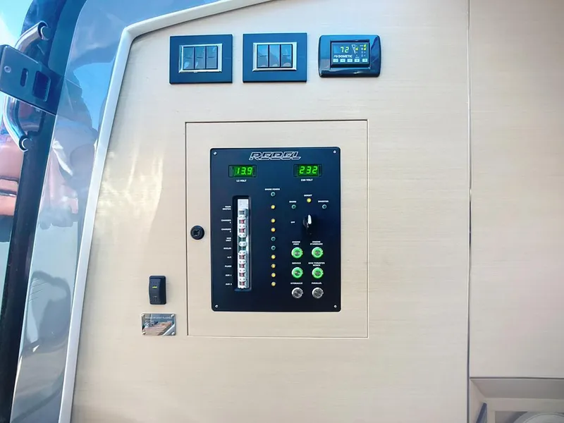 Slide: The Image of Control panel on 2019 SACS Rebel 40 boat, featuring digital displays and switches. - 37