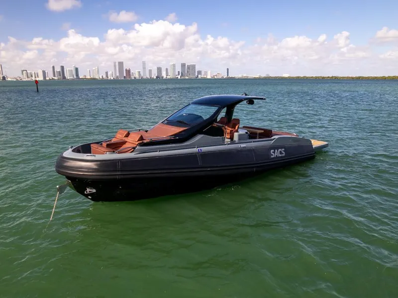 Slide: The Image of 2019 SACS Rebel 40 boat on water with city skyline in background. - 4