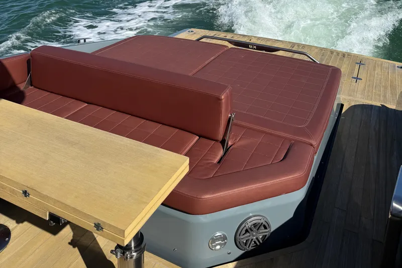 Slide: The Image of Luxurious seating on 2019 SACS Rebel 40 yacht with brown cushions and wooden table. - 9