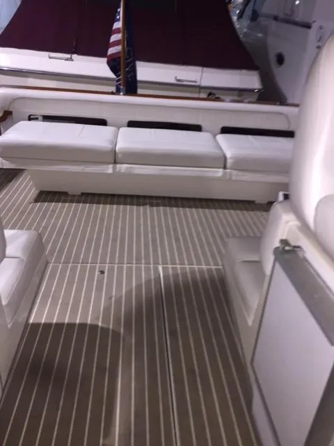 Slide: The Image of 1990 Sea Ray 390 Express Cruiser interior with white seating and striped flooring. - 18