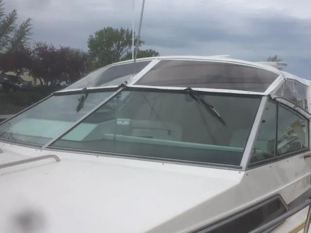 Slide: The Image of 1990 Sea Ray 390 Express Cruiser with sleek windshield design. - 36