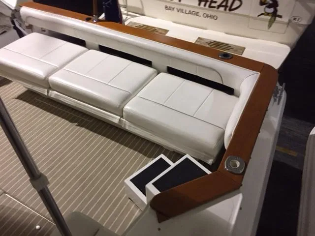 Slide: The Image of 1990 Sea Ray 390 Express Cruiser with white seating and wooden accents on deck. - 4