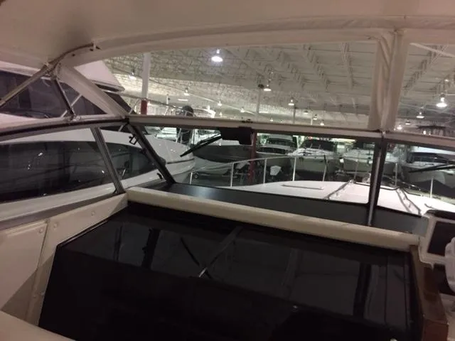 Slide: The Image of 1990 Sea Ray 390 Express Cruiser interior view in a showroom setting. - 45