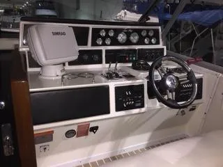 Slide: The Image of 1990 Sea Ray 390 Express Cruiser helm with steering wheel and navigation equipment. - 49