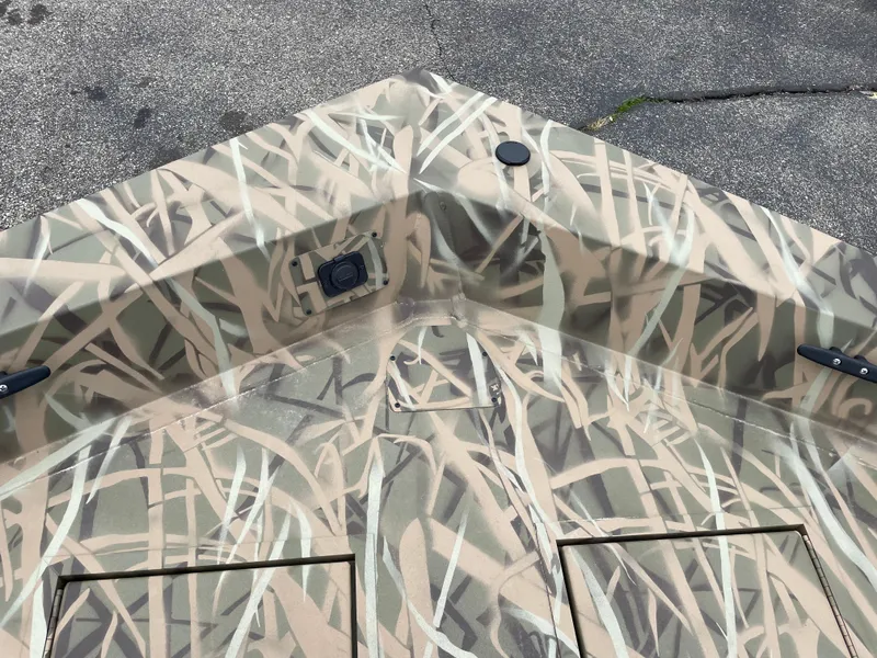 Slide: The Image of 2025 Crestliner 1760 Retriever Jon Deluxe boat with camouflage pattern on deck. - 10