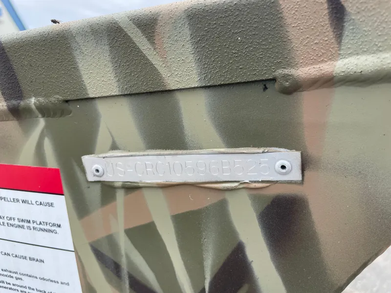 Slide: The Image of 2025 Crestliner 1760 Retriever Jon Deluxe boat with camouflage pattern and identification plate. - 14