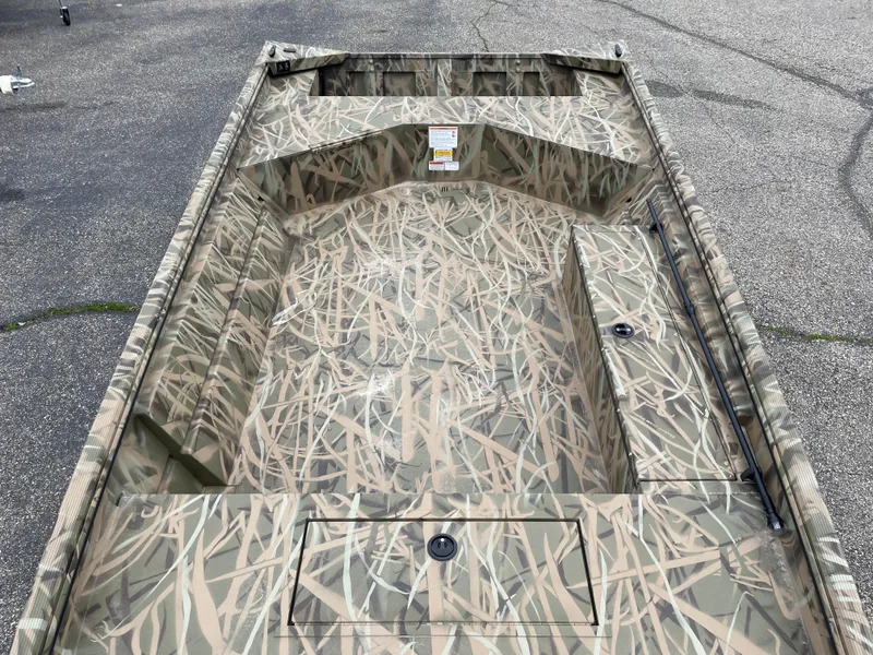 Slide: The Image of 2025 Crestliner 1760 Retriever Jon Deluxe boat with camouflage interior design. - 8