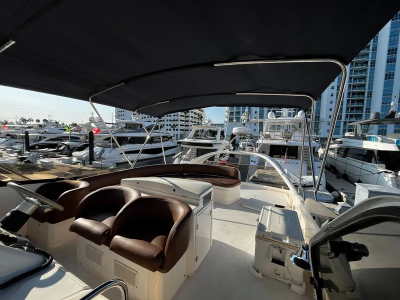 Slide: The Image of 2001 Fairline Squadron 55 yacht interior with seating, docked at a marina. - 10