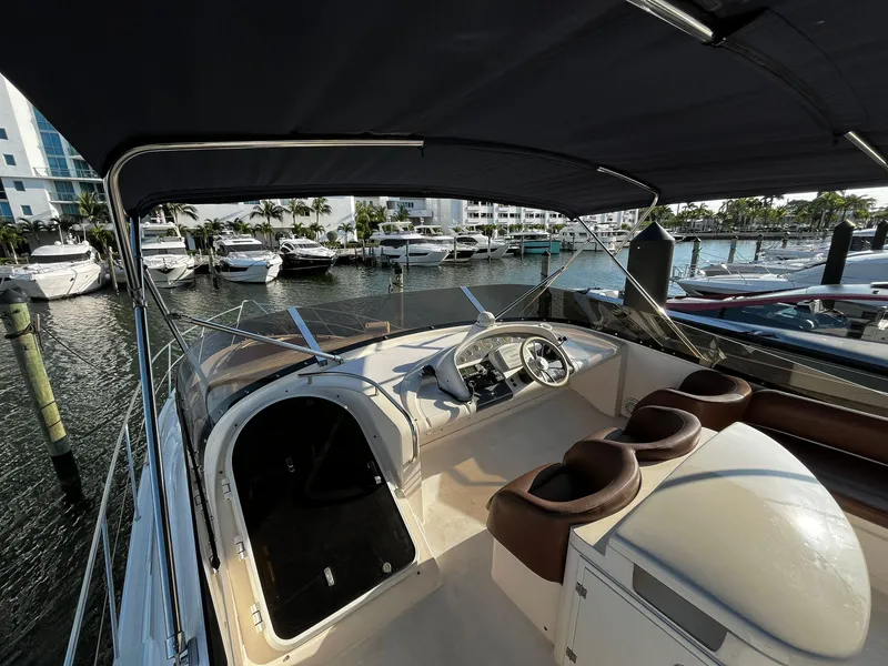 Slide: The Image of 2001 Fairline Squadron 55 yacht cockpit with helm, docked in marina. - 11